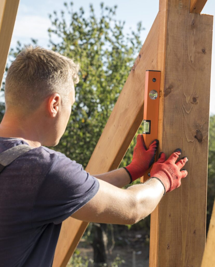 carpenter-man-taking-measures-wood-plank-scaled.jpg