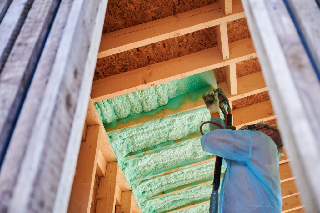 worker-spraying-polyurethane-foam-insulating-wooden-frame-house-scaled.jpg